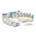 Assorted medical bandages including rolled gauze and adhesive bandages on white background