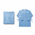 Light blue surgical gown neatly folded on white background